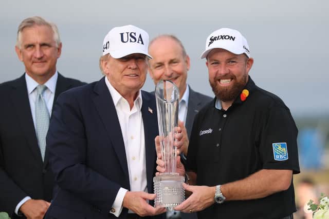 Donald Trump holding the trophy with Shane Lowry
